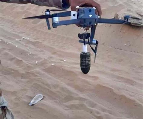 Iraqi forces test fly a drone carrying two grenades in Mosul March 14. . Dropping grenades from drones